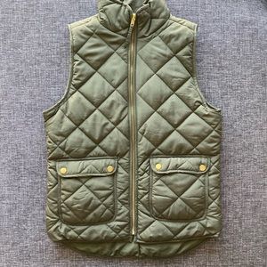 Olive green padded vest with gold accents.